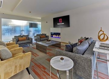 Orange apartment for rent - a living room with couches and chairs and a fireplace