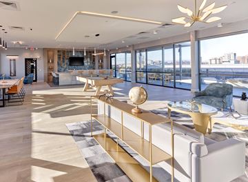 Hackensack apartment for rent - A modern living room with a white sofa and a gold coffee table.