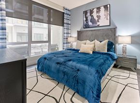 Belleville apartment for rent - A bedroom with a large bed and a painting on the wall.