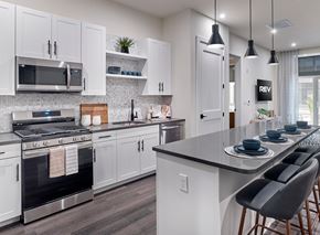 Belleville apartment for rent - A modern kitchen with white cabinets and a black countertop.