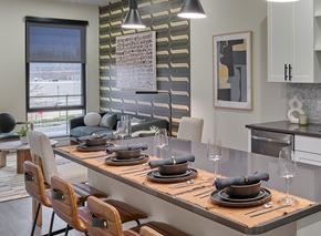 New Brunswick apartment for rent - A modern dining room with a long table set for a meal.