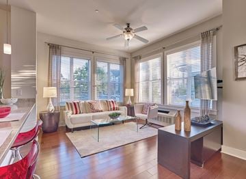 Kearny apartment for rent - A living room with a red chair and a white couch.