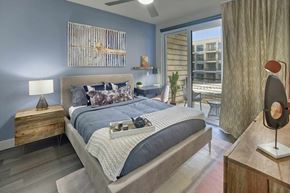 Garwood apartment for rent - A bedroom with a large bed and a wooden nightstand.