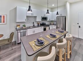 Hackettstown apartment for rent - A modern kitchen with a dining table set for two.