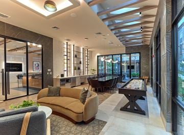Hackettstown apartment for rent - A modern living room with a pool table and a bar area.