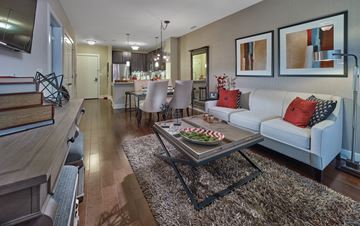 Harrison apartment for rent - A modern living room with a white couch and a coffee table.