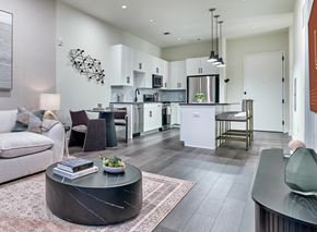 Orange apartment for rent - A modern kitchen with a dining table and chairs.