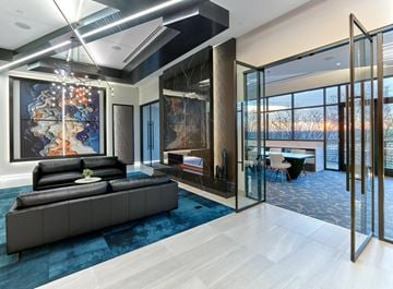 Belleville apartment for rent - A modern living room with a large painting and a black leather sofa.