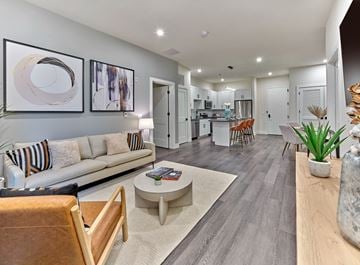 Union apartment for rent - A modern living room with a white sofa and a coffee table.