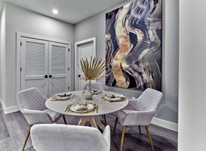 Union apartment for rent - A dining room with a round table set for two and a large abstract painting on the wall.