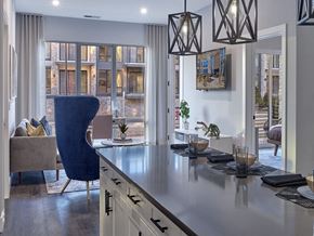 Woodbridge apartment for rent - a kitchen with a counter top in front of a living room