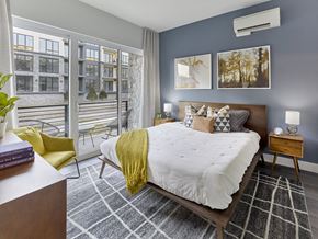 Woodbridge apartment for rent - a bedroom with a large bed and a balcony