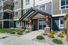 Sylvan Lake apartment for rent - A modern building with a front entrance and landscaping.