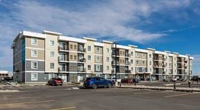 Lethbridge apartment for rent - A four storey apartment building with large parking lot in front