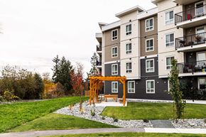 North Cowichan apartment for rent - A large building with a balcony on the right side.