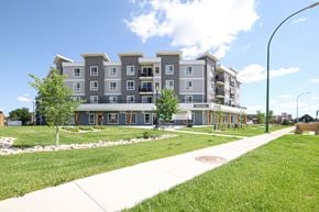 Winnipeg apartment for rent - Apartment building with a sidewalk in front.