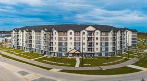 Winnipeg apartment for rent - A large five story apartment complex with parking in behind
