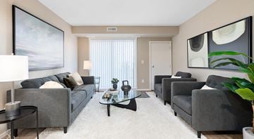 St. Albert apartment for rent - A living room with grey couches and a coffee table.