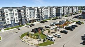Chestermere apartment for rent - A large apartment complex with lots of parking in front
