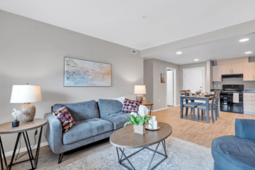 Courtenay apartment for rent - A living room with a grey couch, a coffee table, and a painting on the wall.