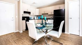 Penticton apartment for rent - A modern kitchen light cabinets and black appliances