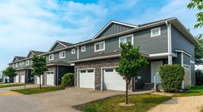 Winnipeg apartment for rent - A row of townhomes with single car garage and driveway