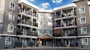 Comox apartment for rent - A large apartment complex with balconies and doors.
