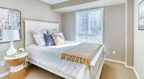 Edmonton apartment for rent - A bedroom with a large bed and a window.