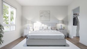 Ottawa apartment for rent - A white bedroom with a large bed and two lamps.