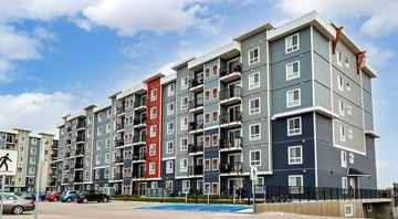 Winnipeg apartment for rent - A large apartment complex with a pool in the courtyard.
