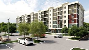 Ottawa apartment for rent - A white car is parked in a parking lot in front of a multi-story apartment building.