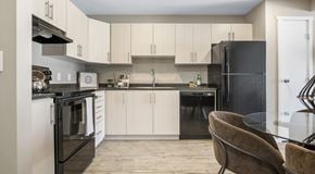 Lethbridge apartment for rent - bright open kitchen with light cabinetry and black appliances