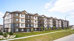 Winnipeg apartment for rent - A row of modern apartment buildings with balconies and multiple stories.