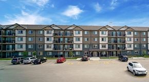 Winnipeg apartment for rent - A large apartment building with lots of parking in front