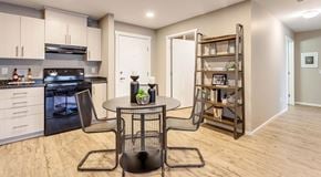 Brandon apartment for rent - a modern open kitchen with dining table, front entrance and laundry room entrance