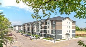 Brandon apartment for rent - A large apartment complex with a parking lot in front.