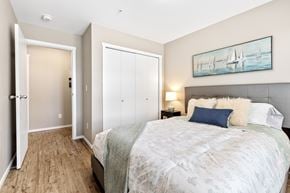 Orleans apartment for rent - A bedroom with a large bed and a painting on the wall.
