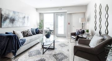 Lethbridge apartment for rent - A living room with a couch, a coffee table, and a painting on the wall.