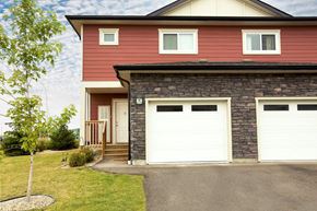 Winnipeg apartment for rent - A red house with a white garage door.