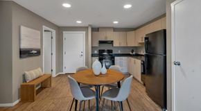 Campbell River apartment for rent - A kitchen with a table and chairs in the middle of the room.