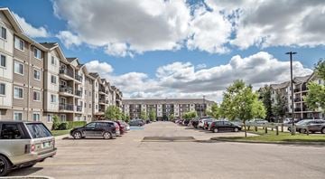 Winnipeg apartment for rent - A parking lot in front of apartment buildings.
