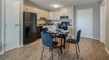 Sylvan Lake apartment for rent - A kitchen with a dining table and chairs.