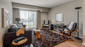 Sylvan Lake apartment for rent - A living room with a couch and chairs, large glass sliding door