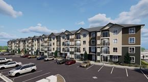 Medicine Hat apartment for rent - A row of modern apartment buildings with cars parked in the lot.