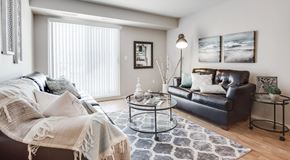 Red Deer apartment for rent - A living room with a couch, a chair, and a coffee table.