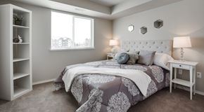 Saskatoon apartment for rent - A bedroom with a large bed and a window.