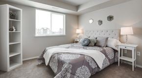 Edmonton apartment for rent - A bedroom with a large bed and a window.