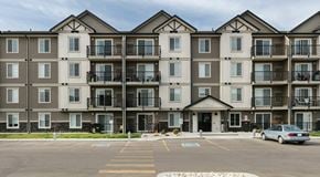 Beaumont townhouse for rent - A large apartment complex with a parking lot in front.
