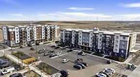 Calgary apartment for rent - Multi building apartment complex with parking lot along side and in front of the buildings