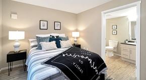 Port Alberni townhouse for rent - A bedroom with queen sized bed, night stands and an ensuite bathroom